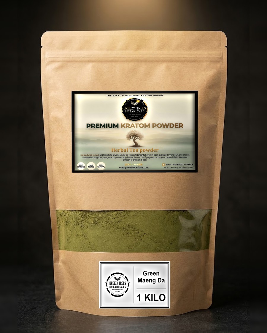 A one kilo Breezy Trees kraft bag held up: the white sticker on the front, the clear window showing green powder, the small strain label at the bottom